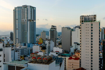 Perspective of a street in Nha Trang with high-rise buildings and hotels view from the roof in the evening