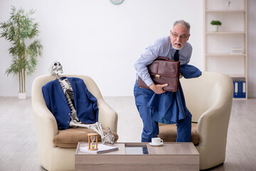 Old businessman meeting with skeleton in business meeting concep