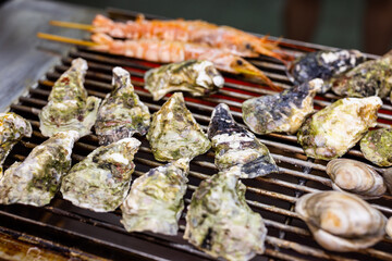 Grill oyster on metal net in street market