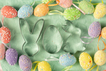 Fototapeta na wymiar The shape of the Easter Bunny on the background of decorative Easter eggs of different colors close-up. Easter holiday