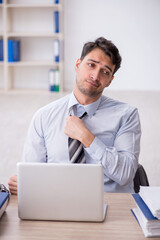 Young male employee working in the office