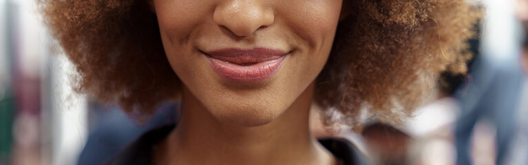 Close up of smiling african businesswoman standing in modern office