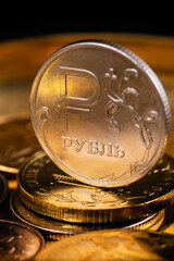 Coin with the symbol of the Russian ruble with a hint of gold color
