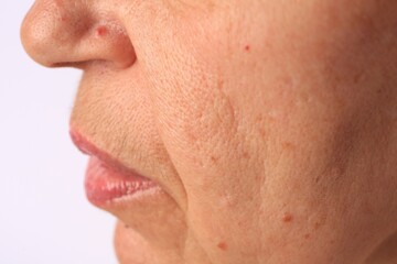 Closeup view of older woman on white background