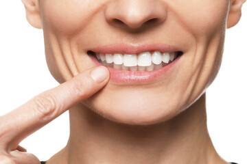 Obraz premium Woman showing healthy gums on white background, closeup