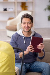 Young man looking after newborn at home