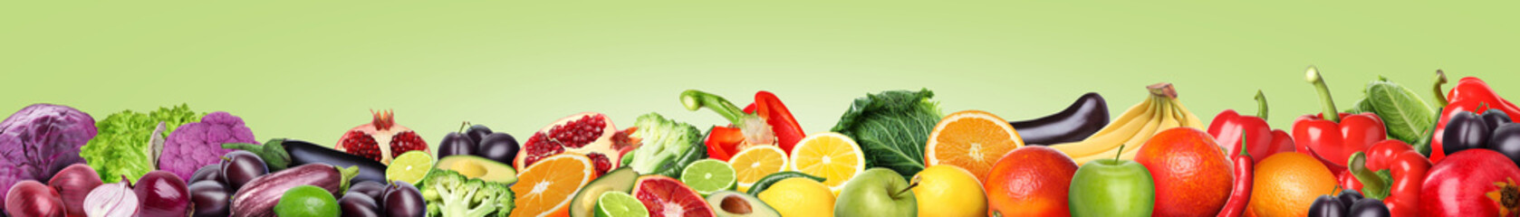 Many different fresh fruits and vegetables on pale light green background. Banner design