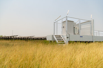 The field of solar panels with an energy storage station located in the middle of a solar cell panel on an area of hundreds of acres