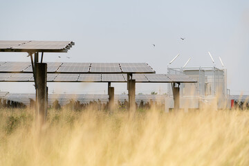 The field of solar panels with an energy storage station located in the middle of a solar cell...
