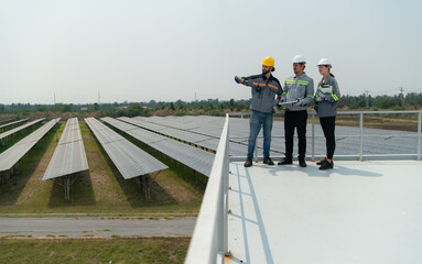 On the rooftop of a large solar energy storage station building A team of electric power engineers...