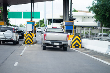 The car pays the cashier for the entrance to the motorway toll gate