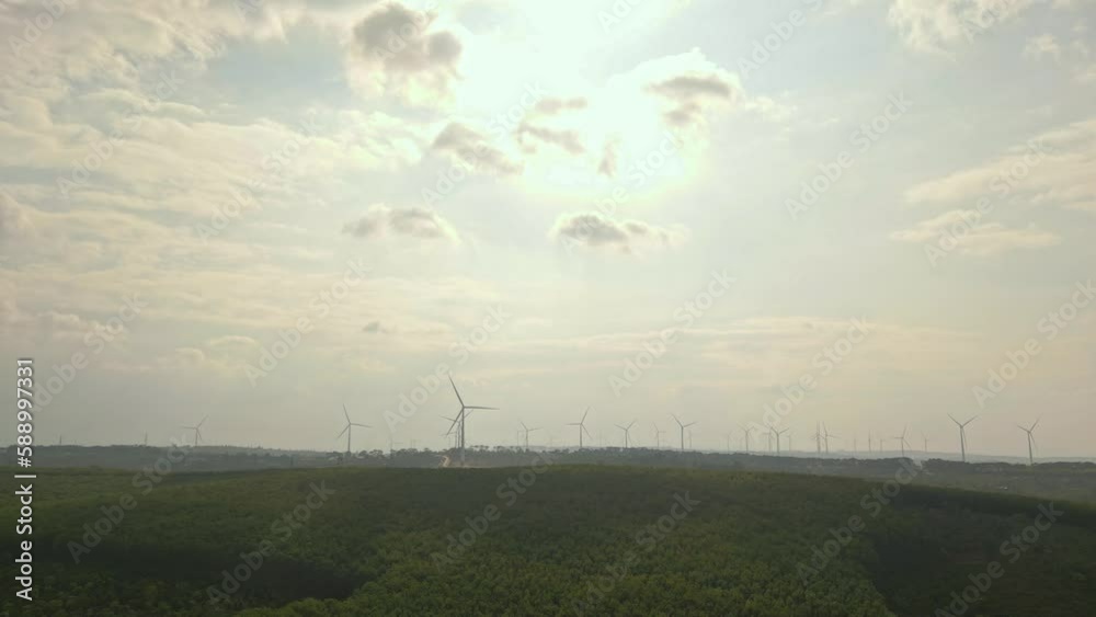 Wall mural drone view of wind farm generating alternative green energy. wind turbines rotating at windmill park