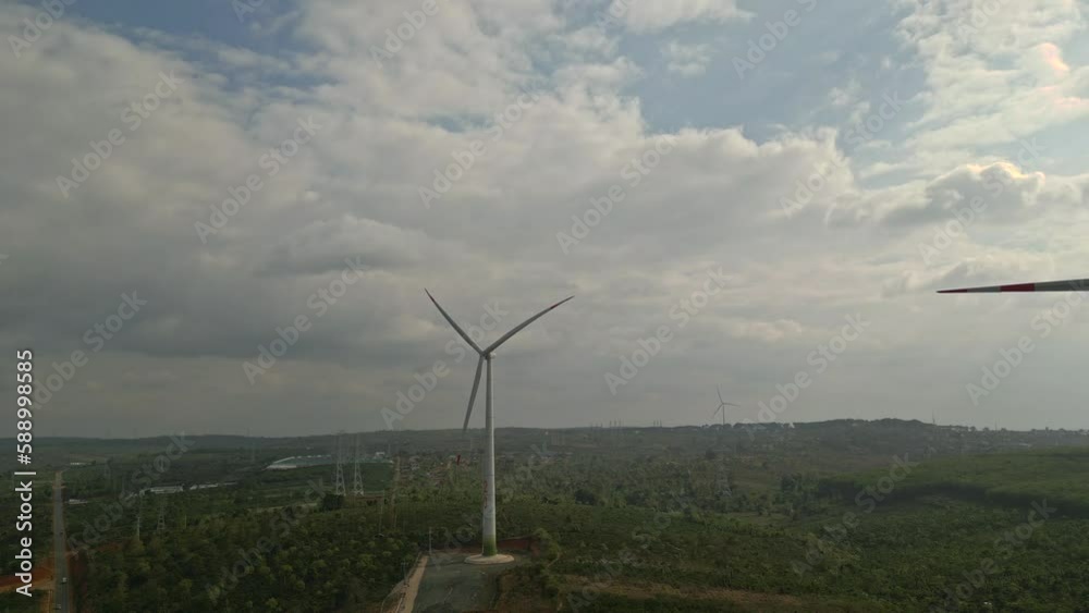 Wall mural drone view of wind farm generating alternative green energy. wind turbines rotating at windmill park