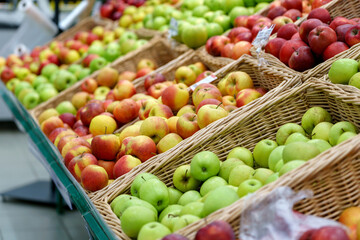 Apples on the shelves of a grocery store. Sale of fresh fruit. Selective focus