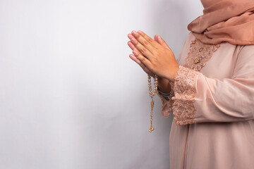 Islamic moslem woman praying with crystal tasbih wearing traditional dress