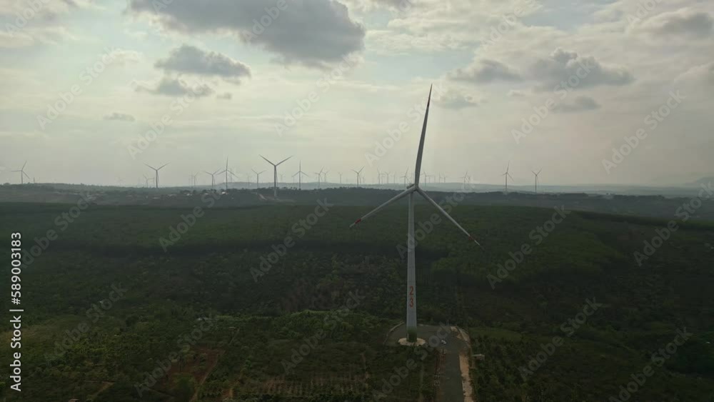 Wall mural drone view of wind farm generating alternative green energy. wind turbines rotating at windmill park