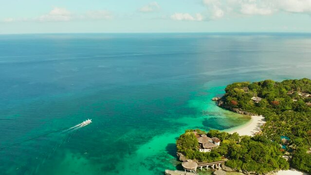 Tropical white sand beach, hotels near the blue lagoon and corall reef. aerial view, Boracay, Philippines. Seascape with beach on tropical island. Summer and travel vacation concept.