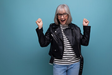 informal energetic healthy gray-haired woman 50s years old grandmother in a rocker jacket on a...