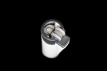 Naklejka premium Stylish small pocket lighter isolated on black background. top view