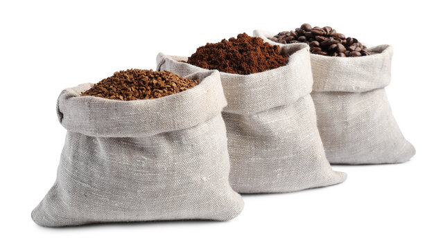 Bags with different types of coffee on white background