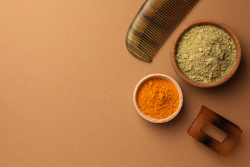 Flat lay composition with henna and turmeric powder on coral background, space for text. Natural...