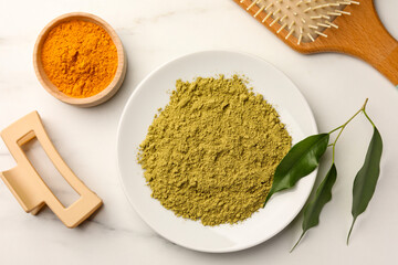 Flat lay composition with henna and turmeric powder on white marble table. Natural hair coloring