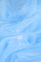 Beautiful light blue tulle fabric as background, top view