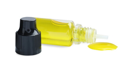 Bottle of yellow food coloring on white background