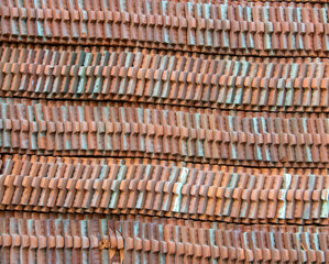 Brown roof tiles lined up in a long line.