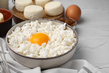Different ingredients on white textured table, space for text. Cooking cottage cheese pancakes