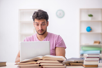 Young male student sitting in the classroom