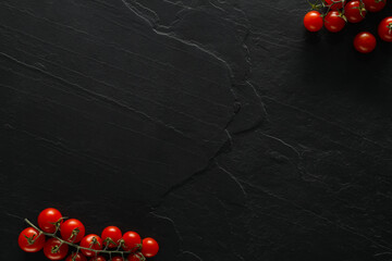 Food photography. Fresh cherry tomatoes on black table, flat lay with space for text