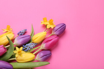 Beautiful different flowers on pink background, flat lay. Space for text