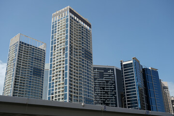 Futuristic and modern commercial and residential highrise tower skyscraper architecture with glass facades and clean lines in downtown Dubai, United Arab Emirates for millionaires and high society