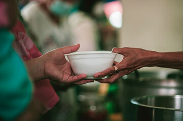 A free food kitchen that feeds hundreds of hungry poor people : problem concepts of disadvantaged people and hunger.