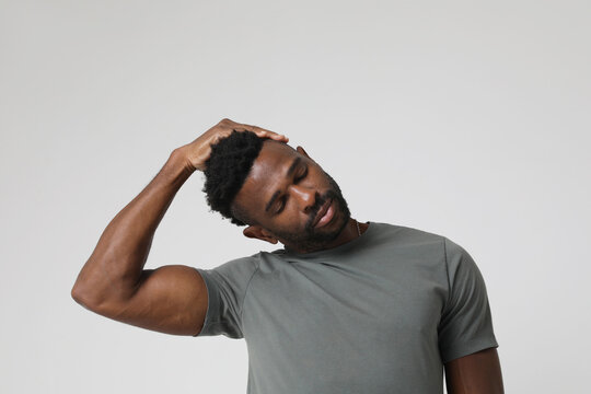African American athletic man doing neck stretching exercises. Mock-up.