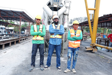 Smiling construction engineers and workers at construction site.