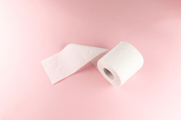 Tissue or toilet paper foroll on pink background with copy space wiping clean. Flat lay and top view image.