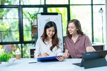 Two female colleagues working together in the office