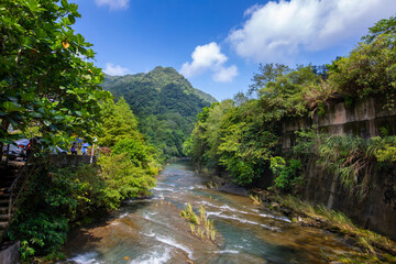 Fototapeta na wymiar Valley, water flow, clean and cool, small stream, mountain, blue sky and white clouds