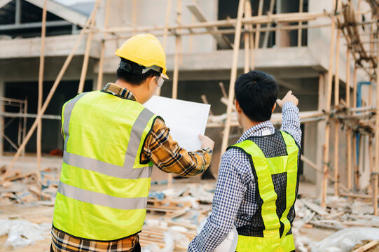 Engineers Are Discussing Data Working And Laptop Or Tablet With Architectural Project At New Construction Site On Big Project. In Sun Light.