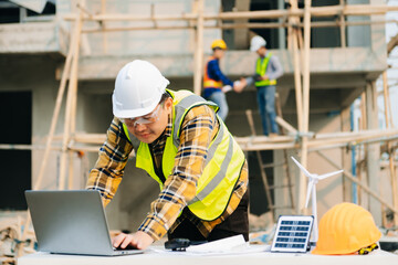 Architect caucasian man working with colleagues mixed race in the construction site. Architecture engineering on big project. Building in construction interior.