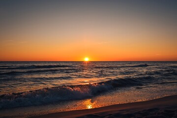 Beautiful colorful landscape on the beach by the sea. Sunrise over the Baltic Sea in Jastarnia, Poland.