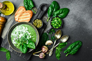 Green Spinach cream soup with cream. In a bowl. Healthy food concept. Close up.