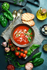 Tomato soup with basil and cream. In a bowl. Healthy food concept. Close up.