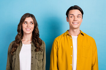 Closeup photo of two young best friends smiling toothy enjoy their beaming smile look each other stomatology advert isolated on blue color background