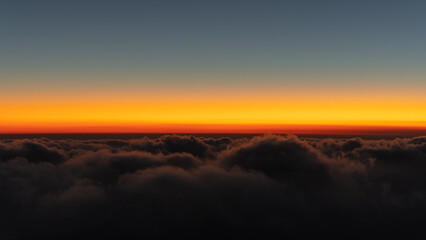 Sunset above clouds