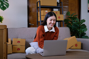 Attractive Asian SME business woman checking order at warehouse