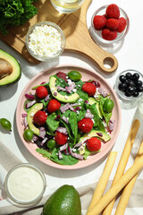 Concept of tasty food, salad with strawberry, top view