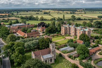 Fototapeta na wymiar Doddington Hall in Lincolnshire northern England, aerial view of Stately Home on a sunny day showing countryside, church and Hall